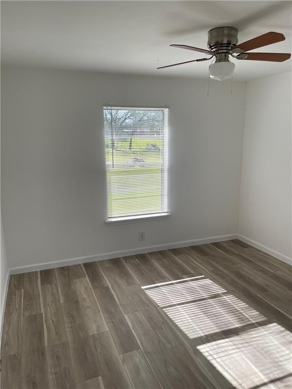 unfurnished room featuring ceiling fan and dark hardwood / wood-style floors