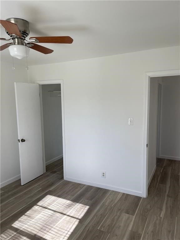 spare room with ceiling fan and dark hardwood / wood-style floors