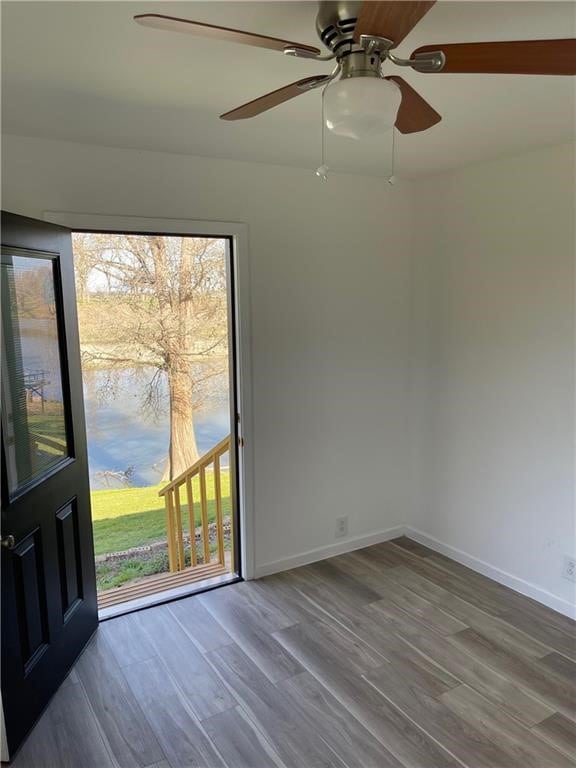 spare room with hardwood / wood-style flooring, ceiling fan, and a wealth of natural light