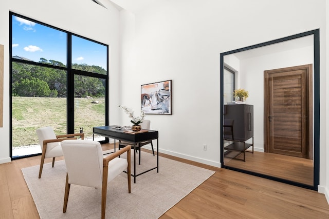 home office with light hardwood / wood-style floors