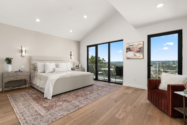 bedroom featuring access to exterior, light wood-type flooring, and multiple windows