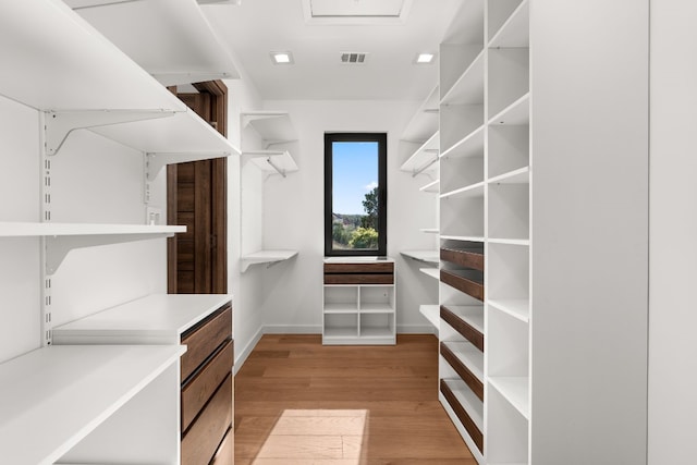 walk in closet featuring light hardwood / wood-style floors