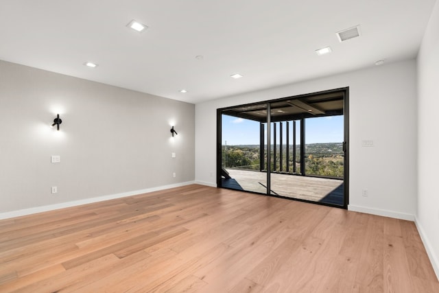 spare room with light hardwood / wood-style flooring