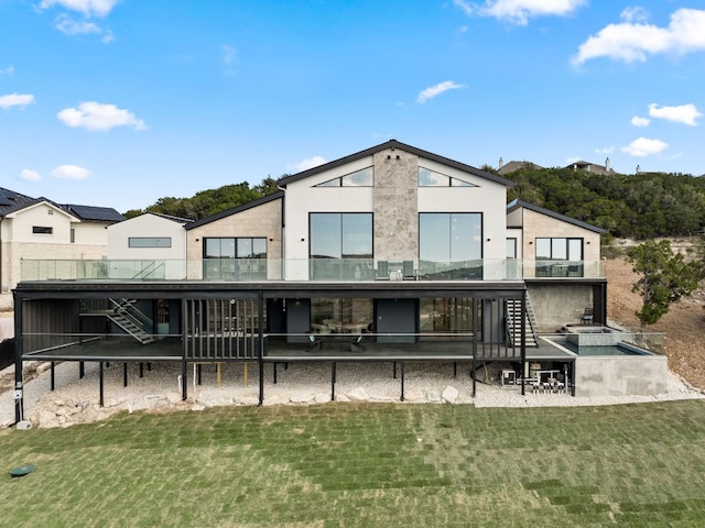 back of property with a yard and a patio