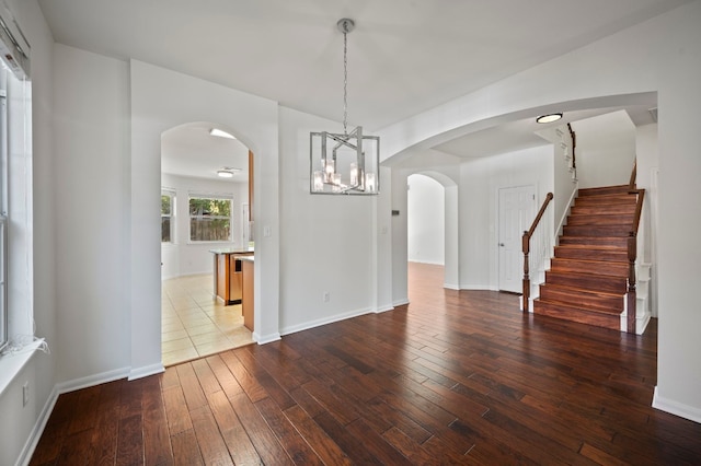 unfurnished dining area featuring hardwood / wood-style floors and a chandelier