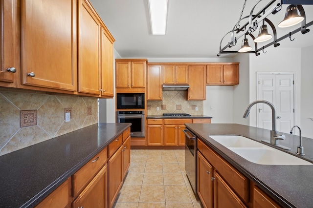 kitchen featuring sink, stainless steel appliances, backsplash, pendant lighting, and light tile patterned floors