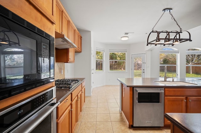 kitchen featuring decorative backsplash, stainless steel appliances, sink, light tile patterned floors, and a notable chandelier