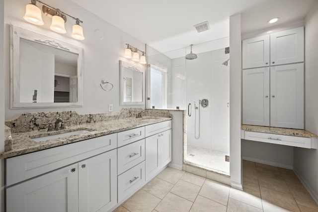 bathroom with tile patterned floors, vanity, and an enclosed shower