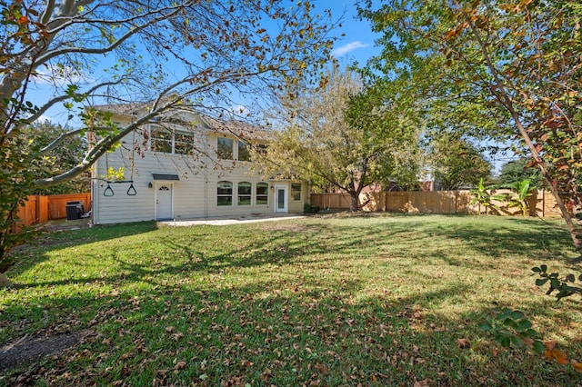 view of yard featuring central air condition unit and a patio