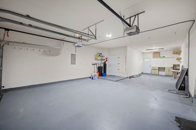 garage featuring electric panel and a garage door opener