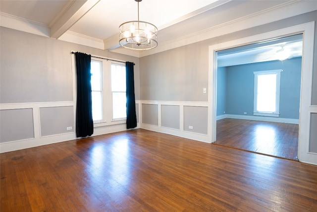 unfurnished room featuring beamed ceiling, dark hardwood / wood-style floors, an inviting chandelier, and crown molding