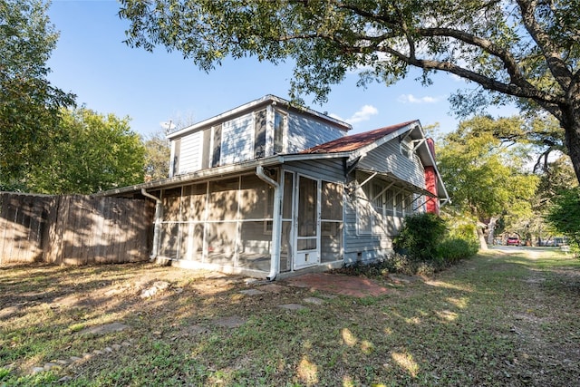 back of house featuring a sunroom