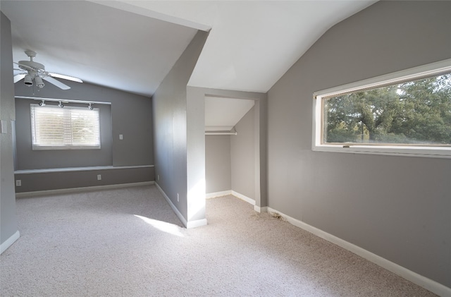 bonus room featuring light carpet, vaulted ceiling, and plenty of natural light