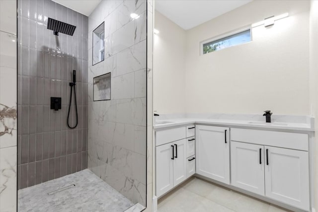 bathroom featuring a tile shower and vanity