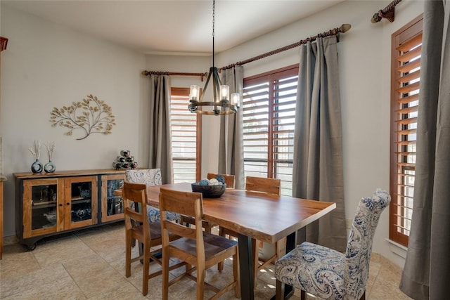 dining space with an inviting chandelier