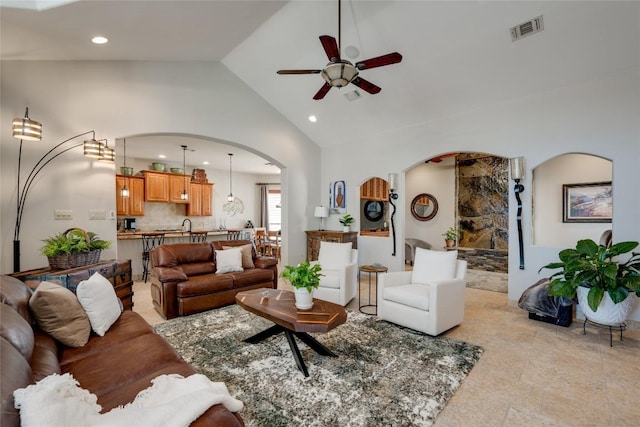 living room with ceiling fan and lofted ceiling