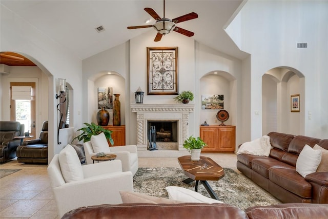 living room with ceiling fan and high vaulted ceiling