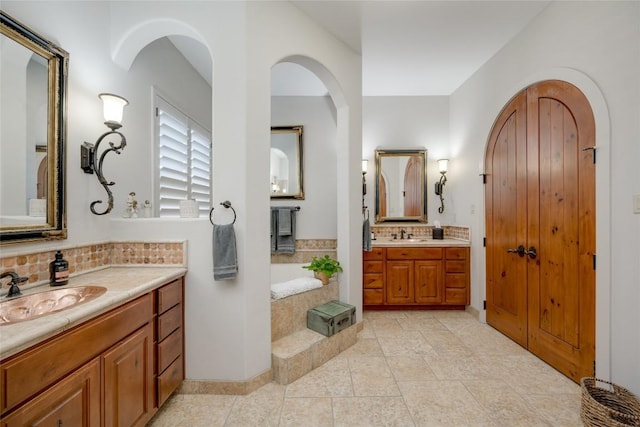 bathroom with tile patterned floors, vanity, and decorative backsplash