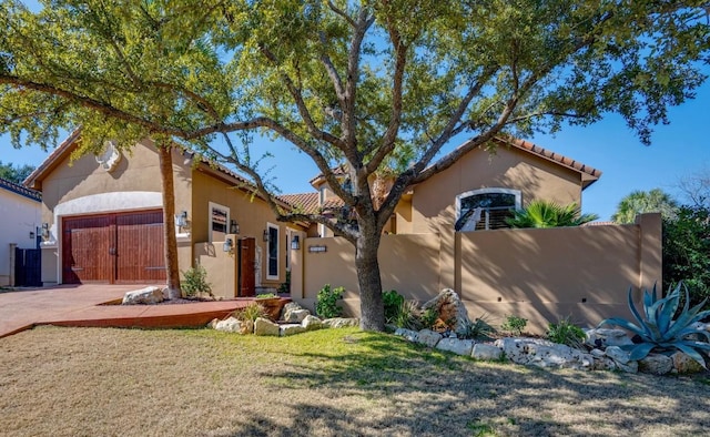 view of front of property with a garage, cooling unit, and a front lawn