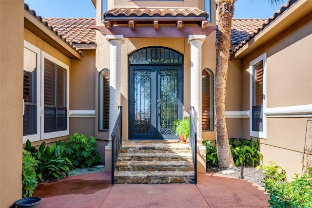 view of exterior entry featuring french doors