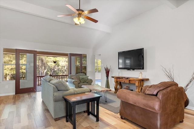 living room featuring ceiling fan, light hardwood / wood-style flooring, beamed ceiling, and high vaulted ceiling