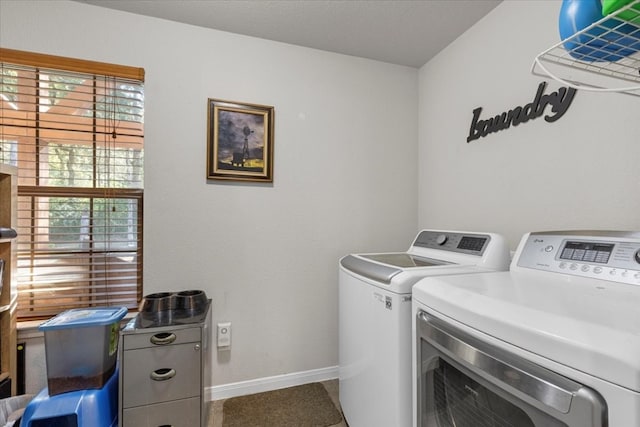 washroom with plenty of natural light and separate washer and dryer