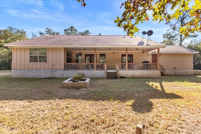 back of house with a porch and a yard