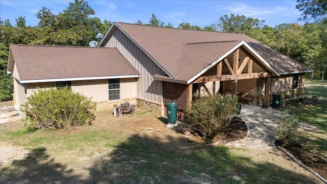 133 Blue Jack Oak Ln, Bastrop, TX 78602 - view of front of property with stone siding, a shingled roof, board and batten siding, and a front yard