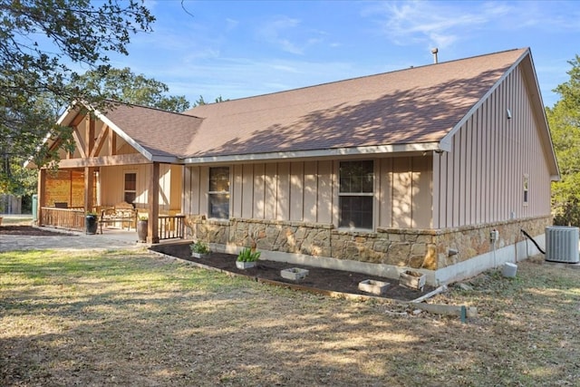 view of front of home with a porch and central air condition unit