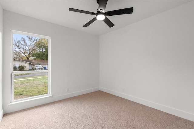 empty room featuring carpet flooring and ceiling fan