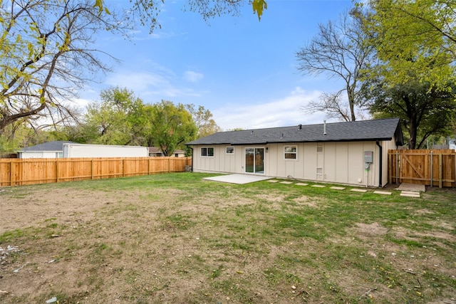 back of house featuring a lawn and a patio