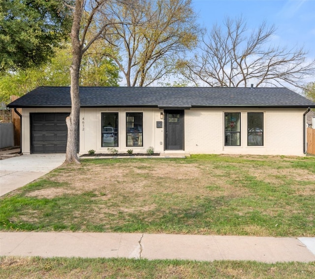 ranch-style house featuring a garage and a front lawn