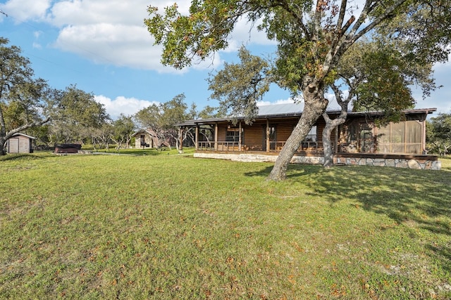 view of yard featuring a storage shed and a sunroom