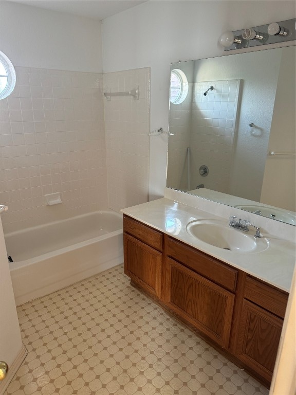 bathroom with vanity and tiled shower / bath combo