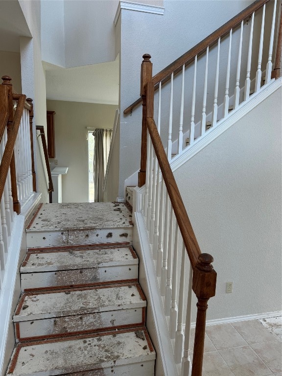 staircase featuring tile patterned floors