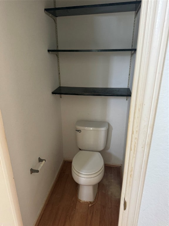 bathroom featuring toilet and hardwood / wood-style flooring