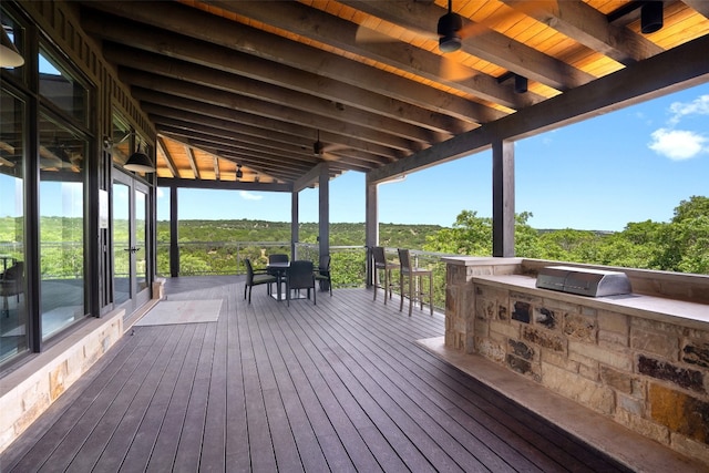 wooden deck with area for grilling and a grill