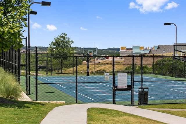 view of sport court featuring tennis court