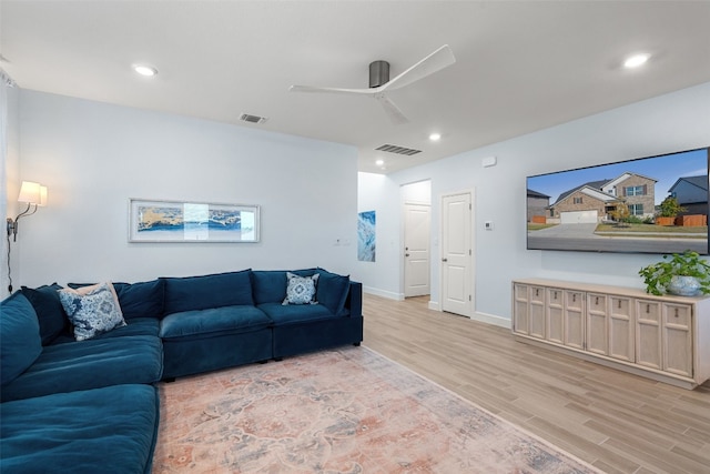 living room with light wood-type flooring and ceiling fan