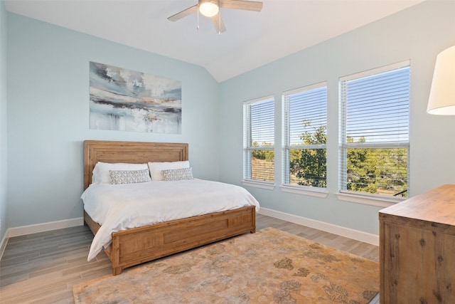 bedroom featuring ceiling fan, wood-type flooring, and lofted ceiling