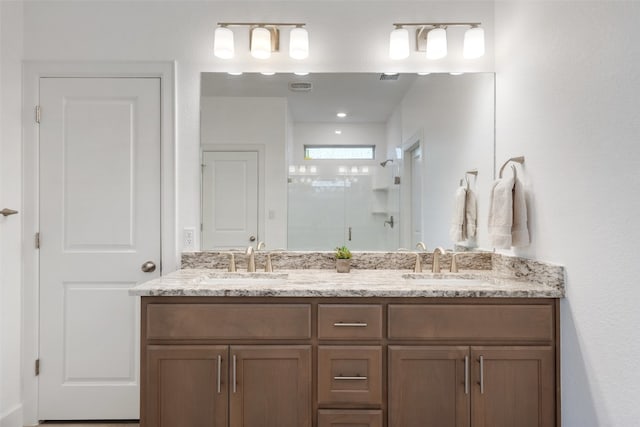 bathroom with vanity and a shower with shower door