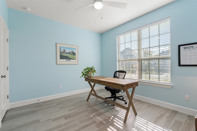 home office with ceiling fan, plenty of natural light, and light wood-type flooring