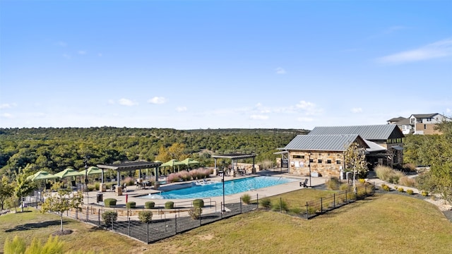 view of swimming pool with a lawn