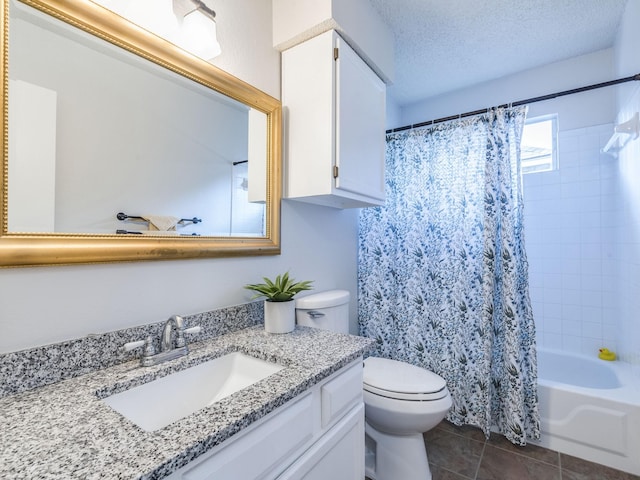 full bathroom featuring tile patterned flooring, vanity, toilet, shower / bath combo, and a textured ceiling