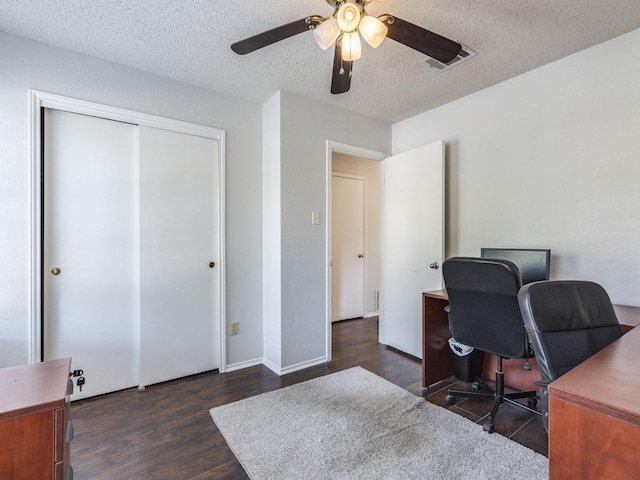 home office featuring dark hardwood / wood-style flooring, a textured ceiling, and ceiling fan