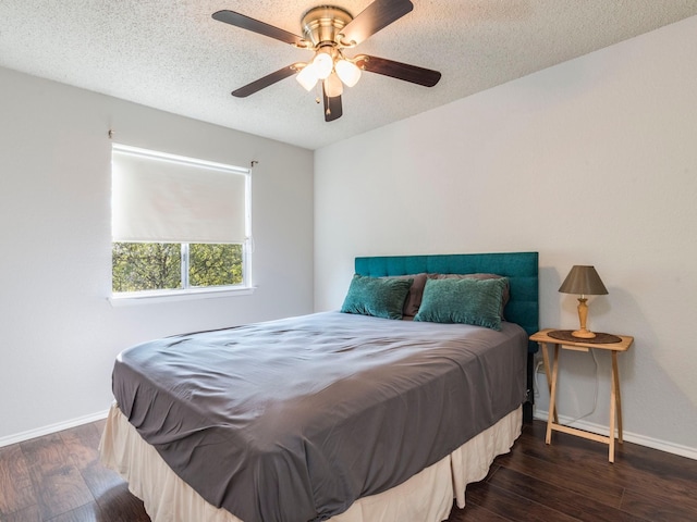 bedroom with a textured ceiling, dark hardwood / wood-style floors, and ceiling fan