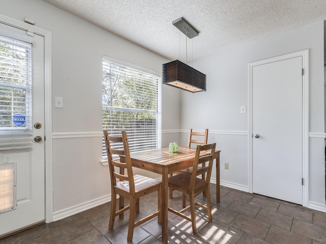 dining space with a textured ceiling