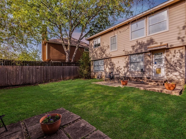 yard at dusk with a patio