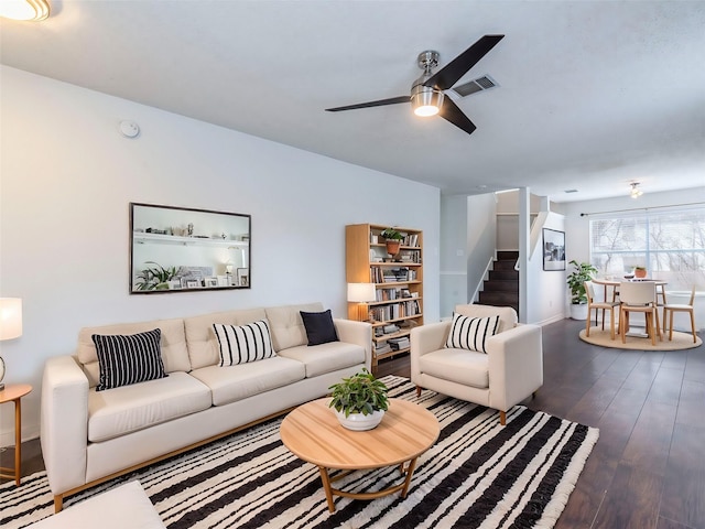 living room with dark wood-type flooring and ceiling fan