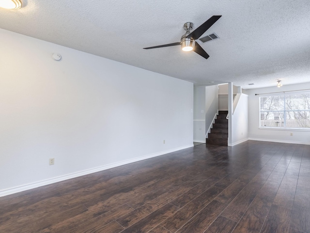 unfurnished living room with ceiling fan, dark wood-type flooring, and a textured ceiling